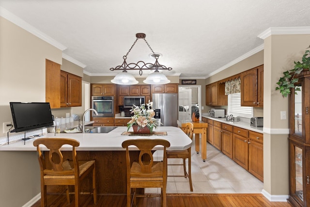 223 Lanetown Rd, Nancy, KY 42544 - kitchen with appliances with stainless steel finishes, brown cabinets, a sink, light countertops, and a peninsula