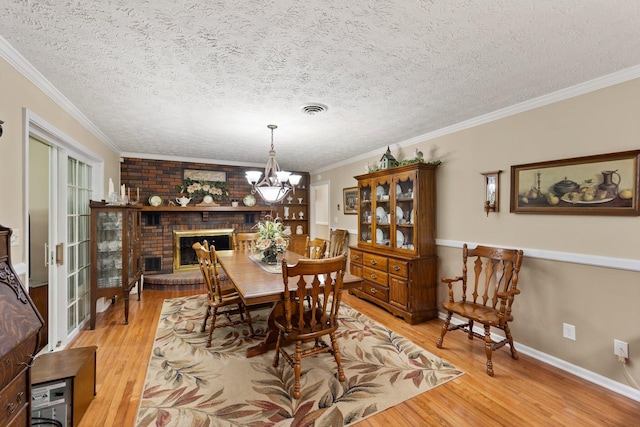 223 Lanetown Rd, Nancy, KY 42544 - dining space featuring light wood-style floors, ornamental molding, a notable chandelier, and visible vents
