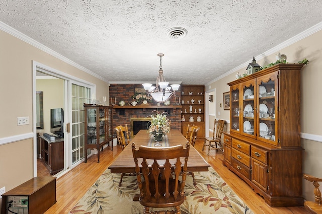223 Lanetown Rd, Nancy, KY 42544 - dining space with visible vents, a textured ceiling, light wood finished floors, and a chandelier