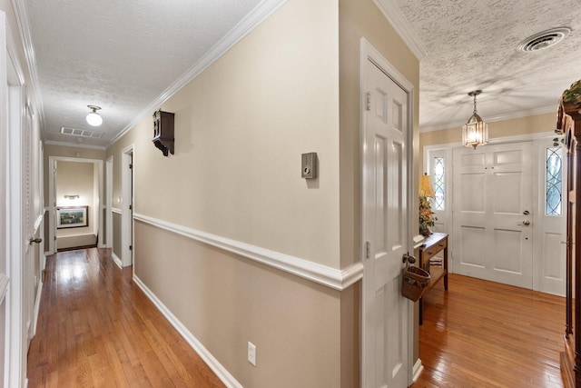 223 Lanetown Rd, Nancy, KY 42544 - hall featuring light wood-style floors, ornamental molding, a textured ceiling, and visible vents