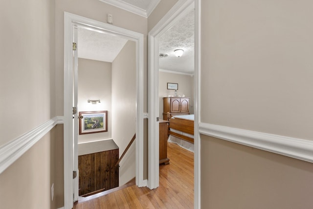 223 Lanetown Rd, Nancy, KY 42544 - corridor with crown molding, light wood-style flooring, a textured ceiling, and an upstairs landing