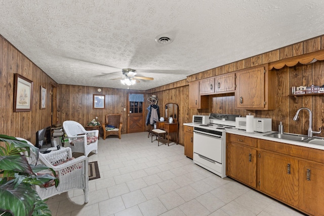 223 Lanetown Rd, Nancy, KY 42544 - kitchen with ceiling fan, electric range, wood walls, a sink, and light countertops