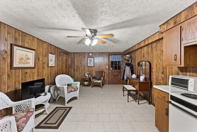 223 Lanetown Rd, Nancy, KY 42544 - living area featuring a ceiling fan, a textured ceiling, a toaster, and wood walls