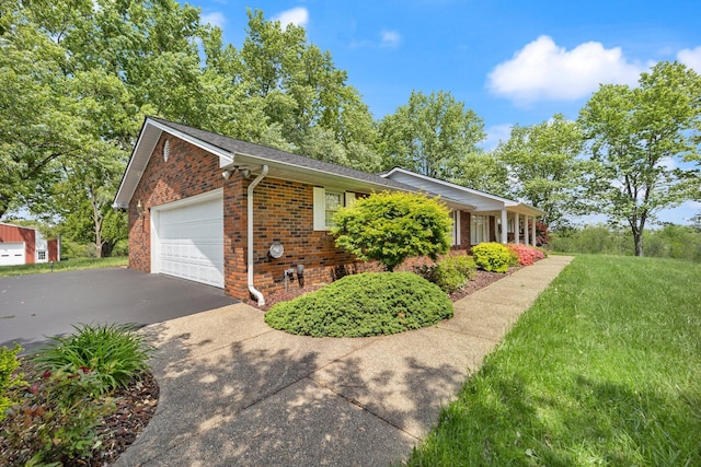 223 Lanetown Rd, Nancy, KY 42544 - view of side of home featuring aphalt driveway, a lawn, roof with shingles, brick siding, and an attached garage