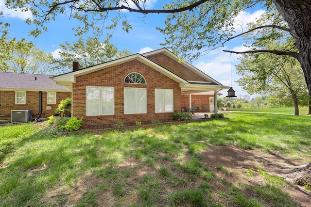 223 Lanetown Rd, Nancy, KY 42544 - view of front of property with brick siding, central AC unit, a chimney, and a front lawn