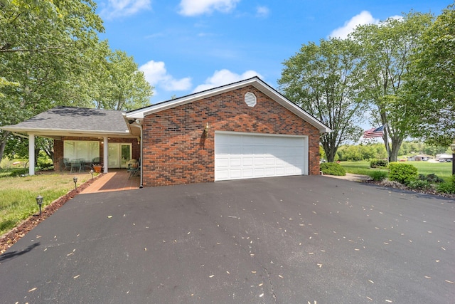 223 Lanetown Rd, Nancy, KY 42544 - view of home's exterior featuring a garage, driveway, and brick siding