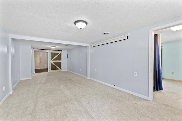 30 Wheeler St, South Shore, KY 41175 - empty room featuring light colored carpet, a barn door, baseboards, and a textured ceiling