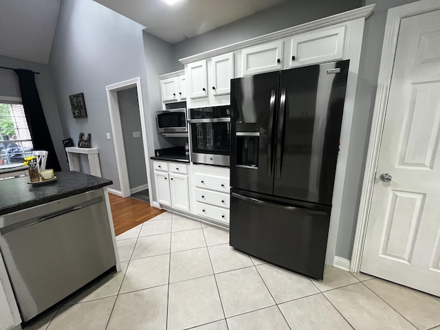 300 Woodlawn Dr, Carrolton, KY 41008 - kitchen featuring stainless steel appliances, dark countertops, white cabinets, light tile patterned floors, and baseboards