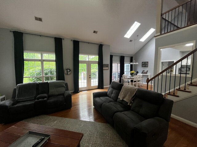 300 Woodlawn Dr, Carrolton, KY 41008 - living room featuring stairway, healthy amount of natural light, wood finished floors, and high vaulted ceiling