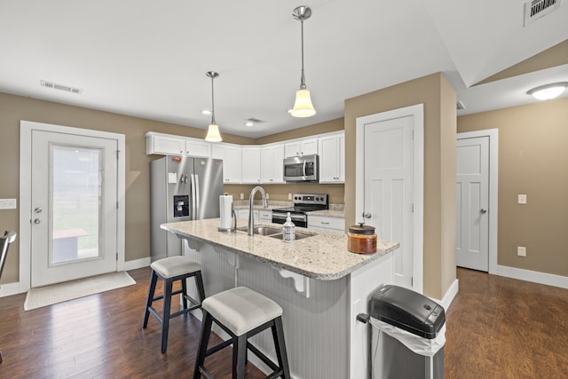 901 Auckland Ave, Richmond, KY 40475 - kitchen featuring stainless steel appliances, baseboards, white cabinetry, dark wood-style floors, and a breakfast bar area