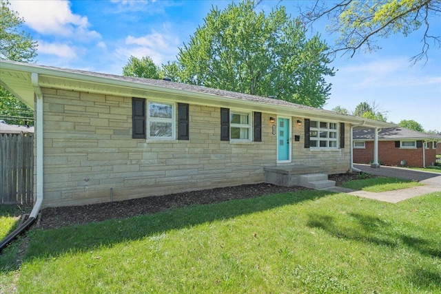 single story home featuring fence, a front yard, and stone siding