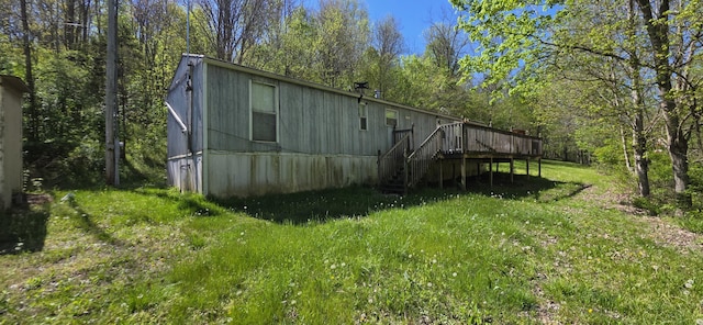 rear view of property featuring a deck and stairs