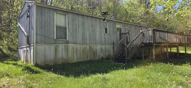 rear view of house with stairs and a wooden deck