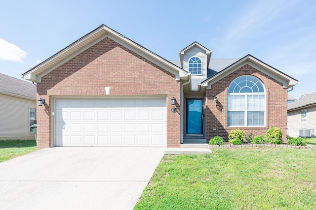 view of front of property with an attached garage, brick siding, a front yard, central AC unit, and concrete driveway