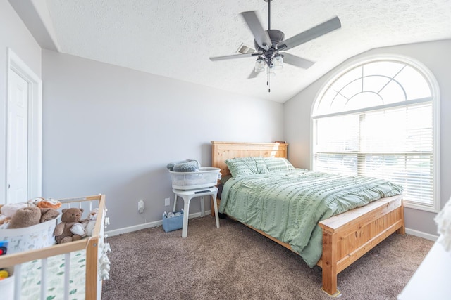 carpeted bedroom with baseboards, multiple windows, vaulted ceiling, and a textured ceiling