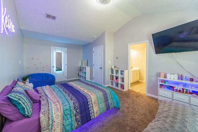 bedroom featuring carpet flooring, connected bathroom, baseboards, vaulted ceiling, and visible vents