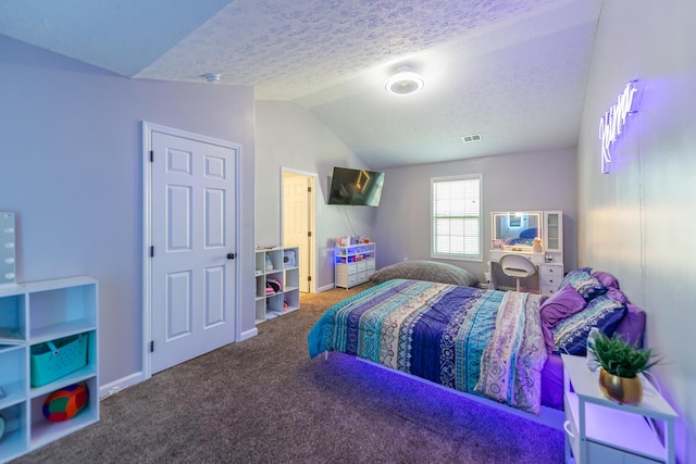 carpeted bedroom featuring visible vents, baseboards, a textured ceiling, and lofted ceiling