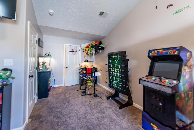 recreation room with a textured ceiling, carpet, baseboards, lofted ceiling, and visible vents