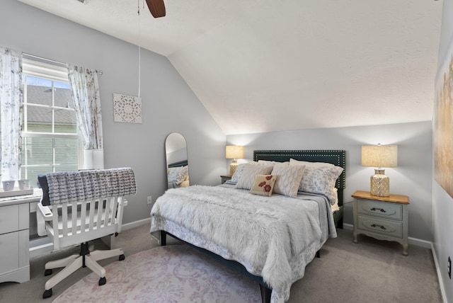 carpeted bedroom with baseboards, a ceiling fan, and vaulted ceiling
