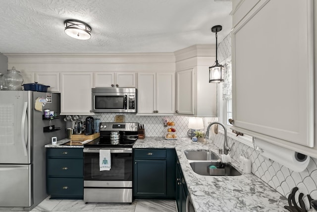 kitchen with light stone counters, a sink, decorative backsplash, and appliances with stainless steel finishes