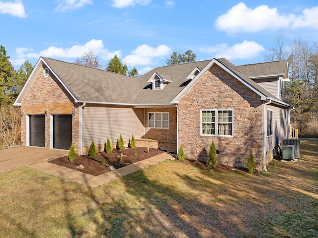 view of front of home featuring stone siding, driveway, a front yard, and a garage