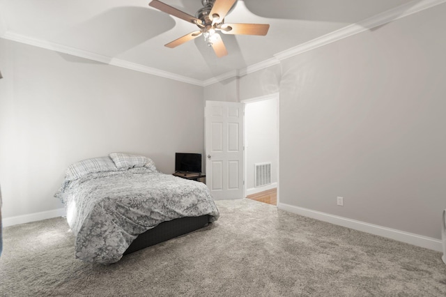 carpeted bedroom featuring crown molding, a ceiling fan, baseboards, and visible vents