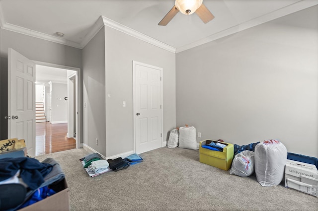 rec room with baseboards, a ceiling fan, carpet, and ornamental molding