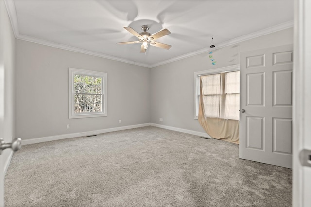 empty room with crown molding, carpet floors, and ceiling fan