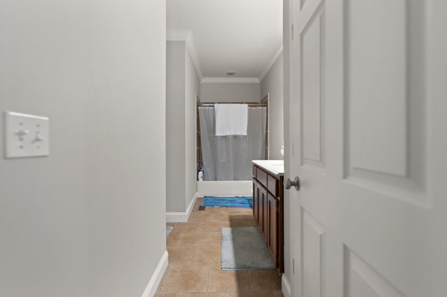 bathroom featuring baseboards, ornamental molding, and vanity