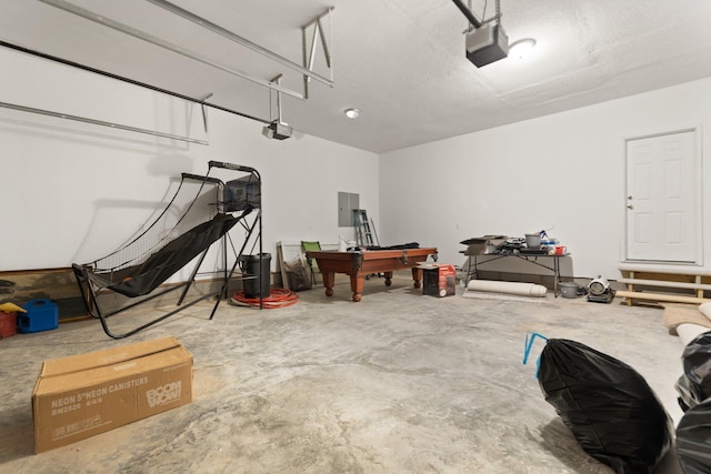 garage with a garage door opener and electric panel
