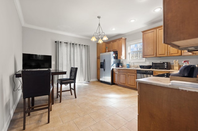 kitchen with crown molding, hanging light fixtures, appliances with stainless steel finishes, and light countertops