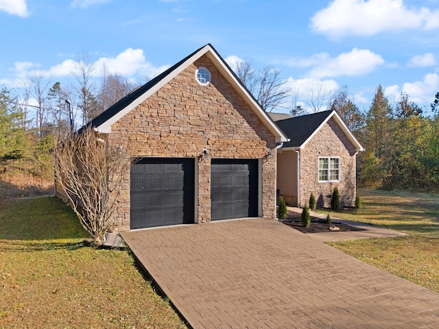 view of front of home featuring a garage, a front lawn, decorative driveway, and stone siding