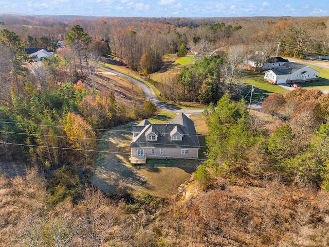 drone / aerial view with a wooded view