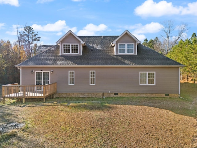 rear view of property featuring a shingled roof, a yard, crawl space, and a deck
