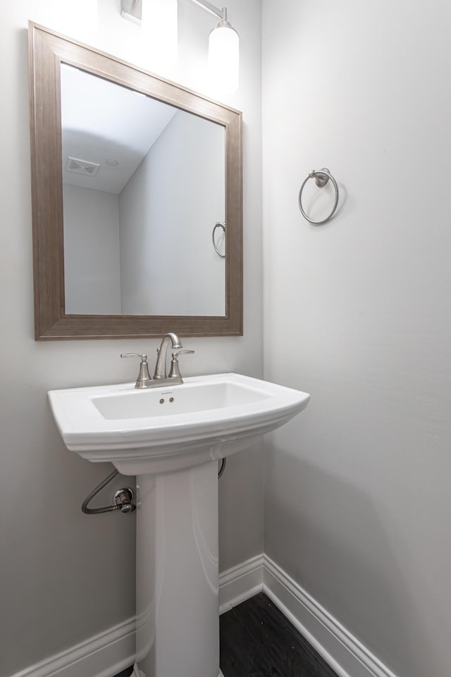 bathroom with baseboards and visible vents