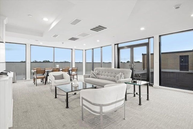 living room featuring recessed lighting, visible vents, light carpet, and expansive windows