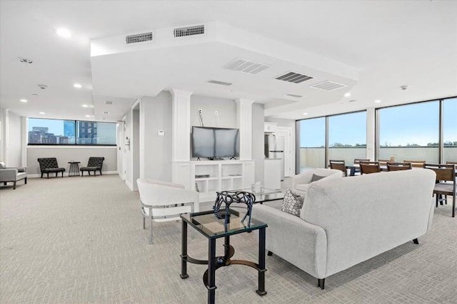 living area featuring recessed lighting, visible vents, and light carpet