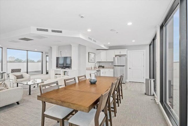 dining space featuring visible vents, recessed lighting, and light colored carpet