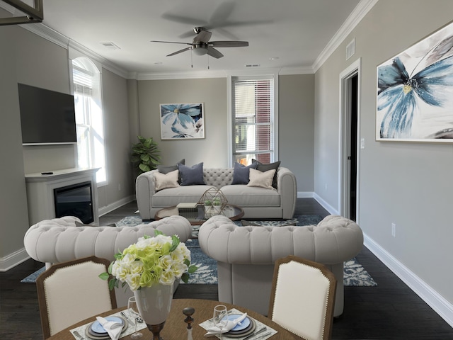 living area with a ceiling fan, visible vents, and dark wood-style floors
