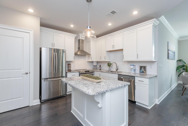 kitchen featuring baseboards, wall chimney range hood, white cabinetry, a sink, and stainless steel appliances