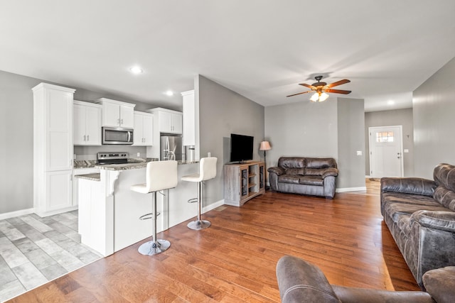 1620 Hannah Dr, Lawrenceburg, KY 40342 - living area with baseboards, a ceiling fan, and light wood-type flooring