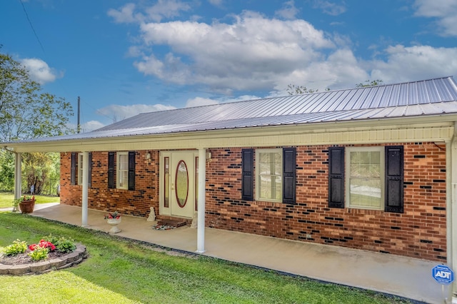 754 Whitt Br, Salyersville, KY 41465 - rear view of property featuring brick siding, a lawn, and metal roof