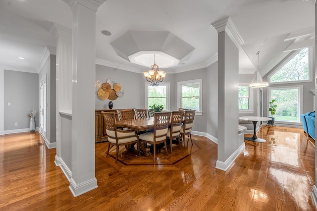 dining area with a healthy amount of sunlight, baseboards, crown molding, and wood finished floors