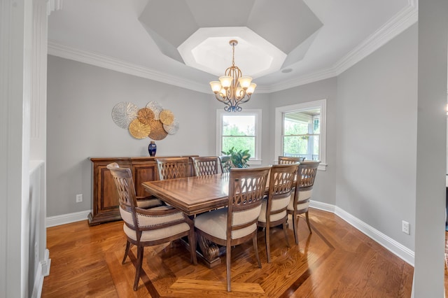 dining room with crown molding, baseboards, wood finished floors, and a notable chandelier