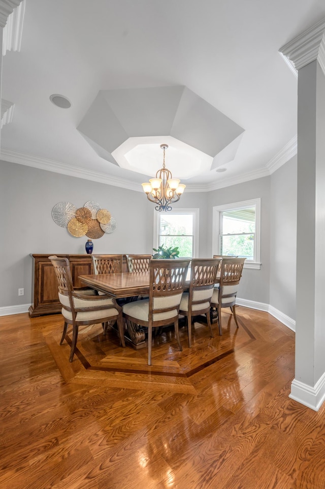 dining area featuring baseboards, ornamental molding, light wood-style floors, and an inviting chandelier