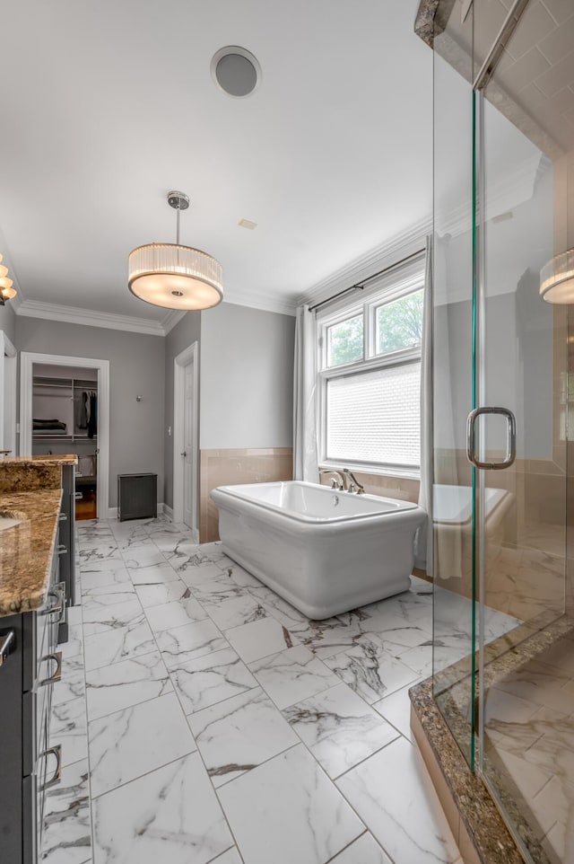 bathroom featuring vanity, ornamental molding, marble finish floor, a freestanding tub, and a stall shower