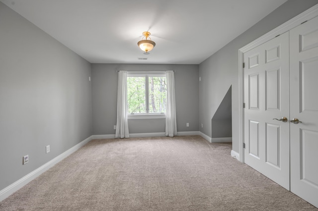 carpeted spare room with baseboards