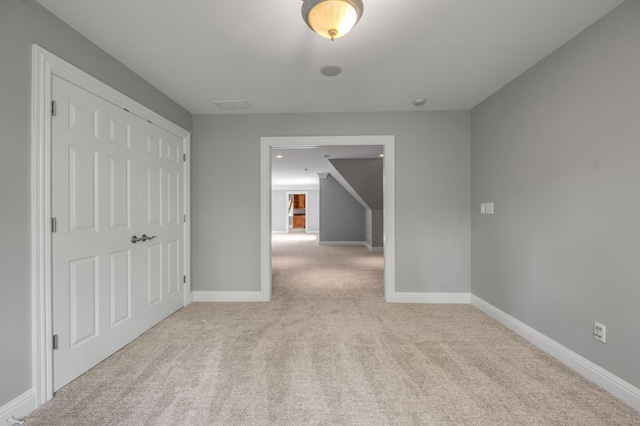 interior space featuring carpet floors and baseboards