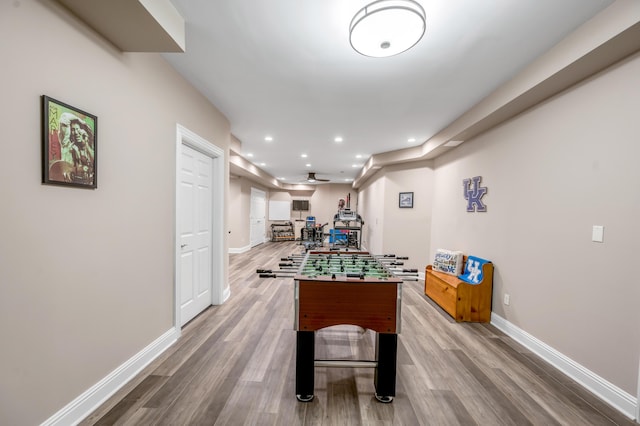 recreation room featuring baseboards, recessed lighting, and wood finished floors