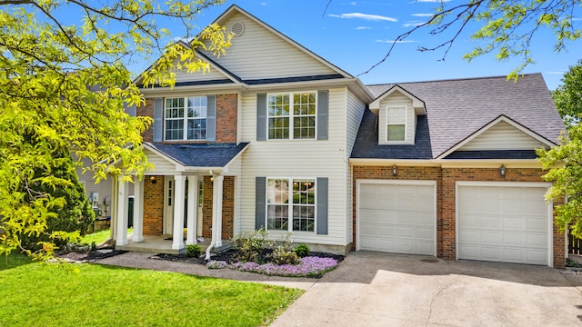 traditional-style house with covered porch, brick siding, an attached garage, and driveway